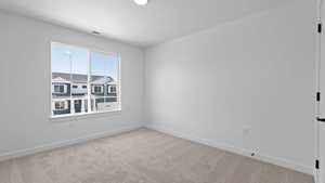 Unfurnished room with carpet floors, baseboards, and visible vents