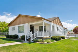 Bungalow-style house with fence and a front yard