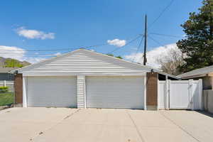 Detached garage featuring a gate and fence