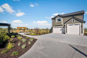 View of front of property featuring an attached garage and driveway