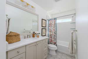 Full bathroom with visible vents, shower / bath combination with curtain, vanity, tile patterned floors, and toilet