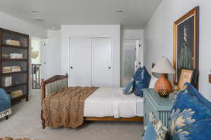 Bedroom featuring carpet, a closet, and visible vents
