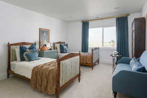 Bedroom featuring baseboards, light colored carpet, and visible vents