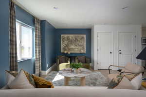 Living area featuring baseboards, recessed lighting, and wood finished floors