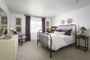 Bedroom featuring baseboards, recessed lighting, and light carpet