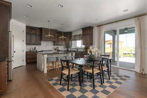 Dining room with recessed lighting, a textured ceiling, and dark wood-type flooring