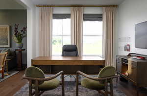 Home office with dark wood-style flooring