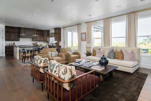 Living area featuring recessed lighting, baseboards, and dark wood-type flooring