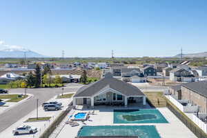 Community pool with a fenced backyard, a mountain view, a patio area, and a residential view