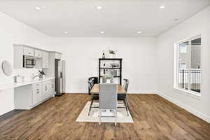 Dining area with recessed lighting, baseboards, and dark wood finished floors