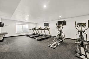 Workout area with baseboards, recessed lighting, a textured ceiling, and visible vents