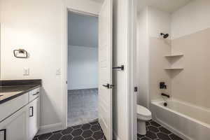 Bathroom featuring vanity, tile patterned floors, shower / bathtub combination, and toilet