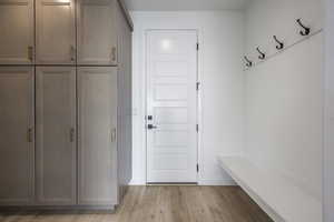 Mudroom with baseboards and light wood finished floors