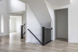 Stairs with baseboards and wood finished floors