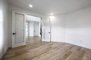 Spare room featuring recessed lighting, baseboards, and light wood-type flooring