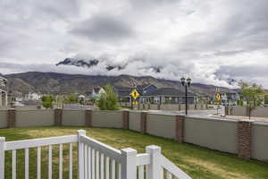 View of yard featuring a fenced backyard, a mountain view, and a residential view