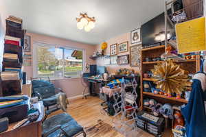 Office with baseboards and wood finished floors