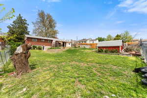 View of yard with a fenced backyard, an outdoor structure, and a shed