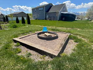 View of yard with fence and a fire pit