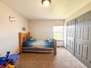 Carpeted bedroom with a textured ceiling