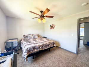 Bedroom featuring carpet flooring, a ceiling fan, and baseboards
