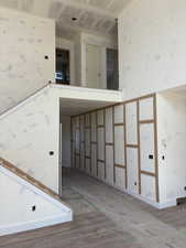 Stairway with baseboards and wood finished floors