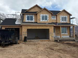 Unfinished property featuring a garage and central AC unit