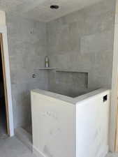 Bathroom featuring a tile shower