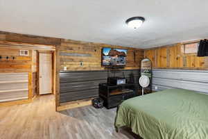 Family Room used as suite with wood walls and industrial siding