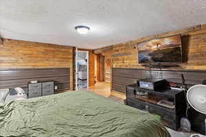 Family Room used as suite with wood walls and industrial siding