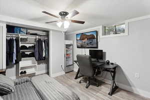 Office/bedroom area featuring a textured ceiling, ceiling fan, and vinyl floors