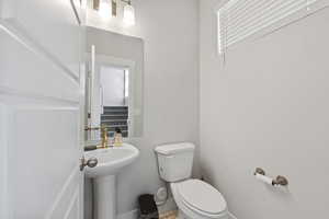Bathroom with baseboards and toilet
