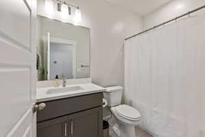 Full bath featuring toilet, tile patterned flooring, and vanity