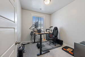 Workout area with visible vents, baseboards, and carpet floors