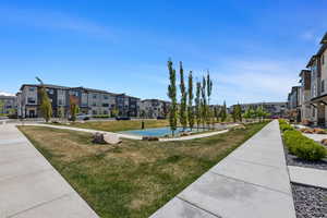 View of property's community with a lawn, community basketball court, and a residential view