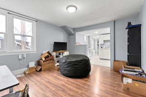 Living area with baseboards and light wood-type flooring