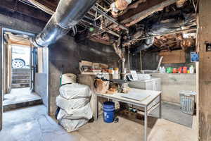 Below grade area with washing machine and clothes dryer