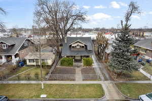 View of front facade with a front lawn, a fenced front yard, covered porch, and a residential view