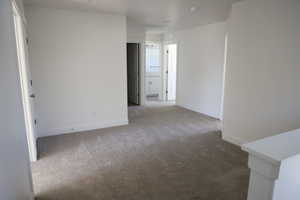 Spare room featuring baseboards, carpet flooring, and visible vents