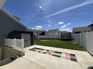 View of patio / terrace featuring a fenced backyard, a trampoline, a playground, and a mountain view