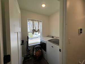 Washroom featuring recessed lighting, laundry area, washing machine and dryer, and dark wood finished floors
