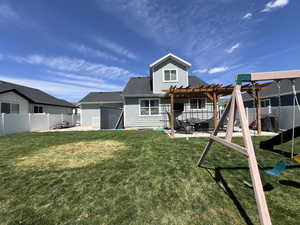 Rear view of property featuring a yard, a patio, a fenced backyard, and a pergola