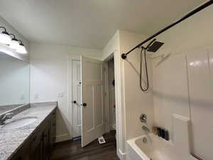 Primary Master Full bathroom with vanity, baseboards, washtub / shower combination, and wood finished floors