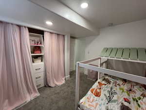 Bedroom featuring recessed lighting and dark colored carpet
