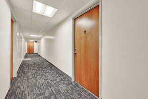 Hall featuring a paneled ceiling