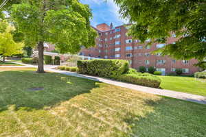 View of home's community with a yard
