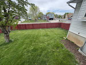 View of yard with a residential view and fence