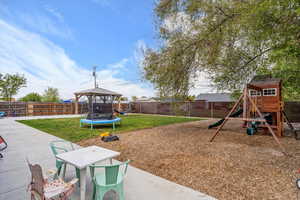 View of play area featuring a yard, a patio, a gazebo, and a fenced backyard