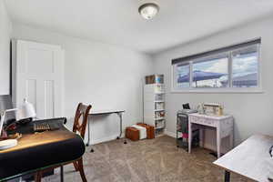 Carpeted office space featuring baseboards