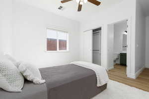 Bedroom featuring visible vents, a closet, baseboards, ceiling fan, and light wood-type flooring
